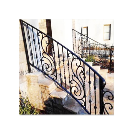 Decorated wrought iron stair railing in front of entry door